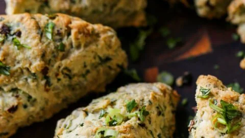 Freshly baked spinach and cheese savory scones on a wooden table