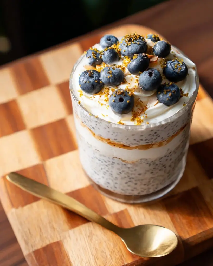 High protein coconut cream pie chia pudding topped with coconut flakes