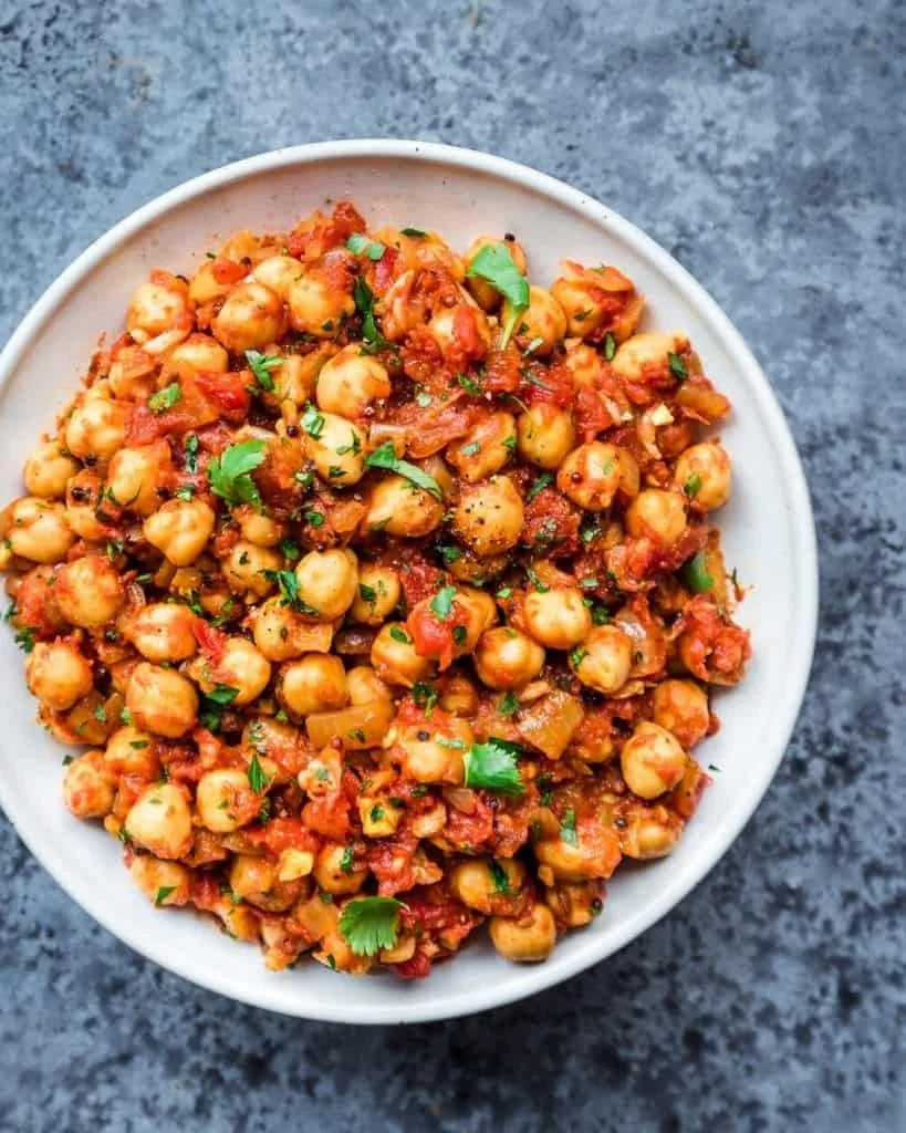 Delicious Vegan Instant Pot Chickpea Masala served in a bowl with fresh herbs