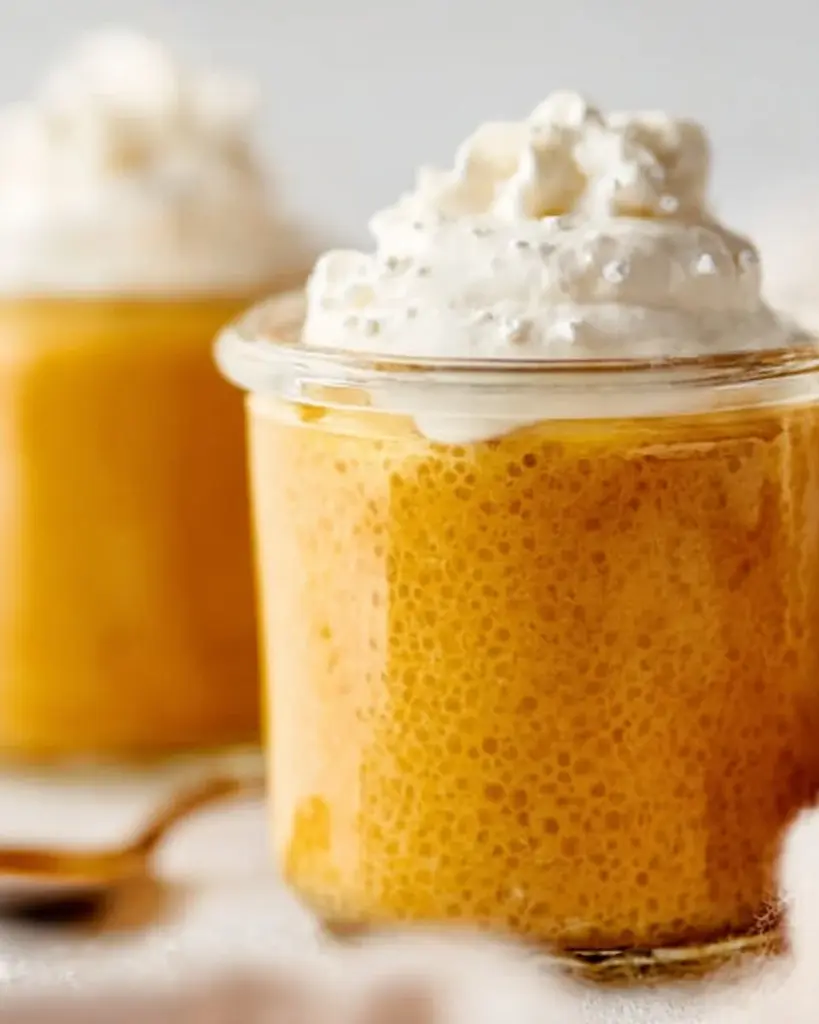 A bowl of Pumpkin Chia Seed Pudding topped with walnuts and spices