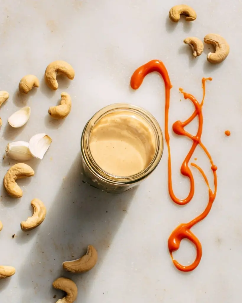 Sriracha Cashew Cheese Sauce aioli served in a bowl with ingredients
