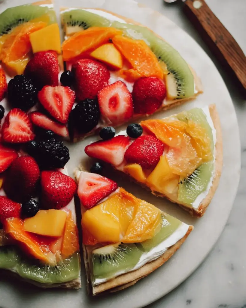 Delicious fruit pizza topped with fresh fruits and a creamy base